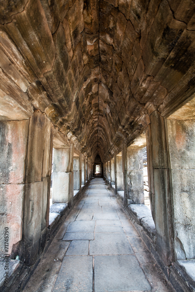 The ancient ruins of a historic Khmer temple in the temple compl
