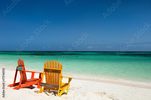Colorful lounge chairs at Caribbean beach © BlueOrange Studio