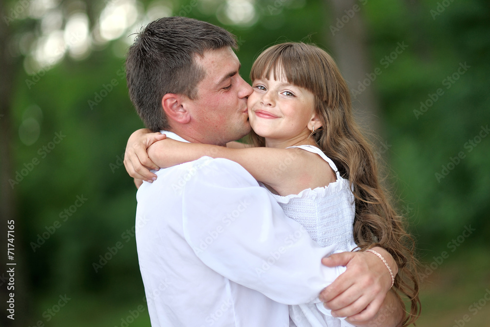 portrait of a happy family in summer nature