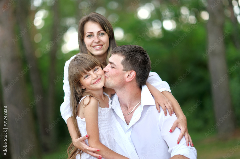 portrait of a happy family in summer nature