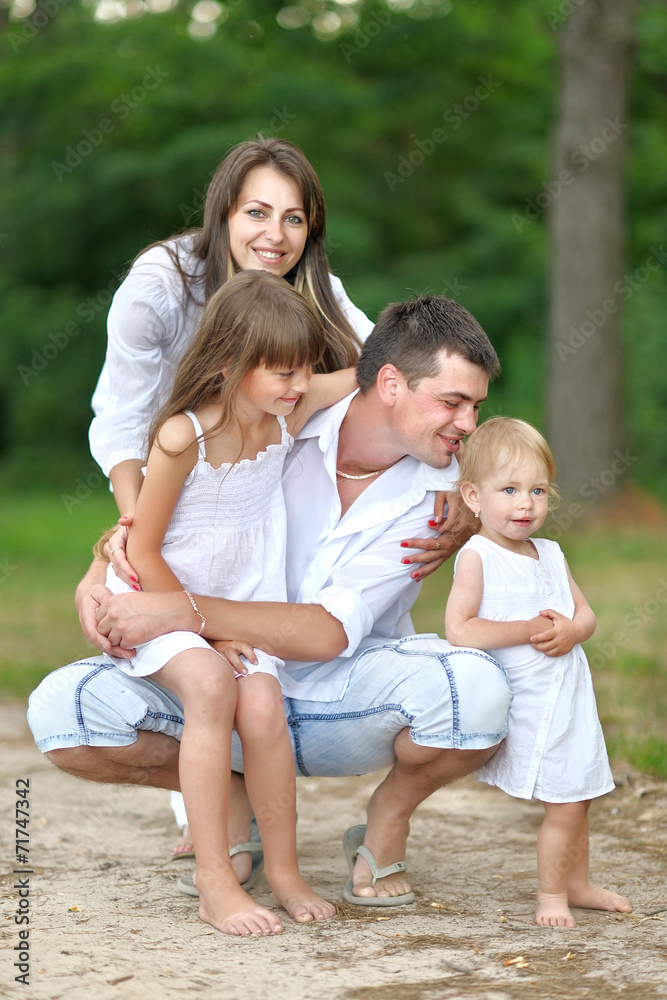 portrait of a happy family in summer nature