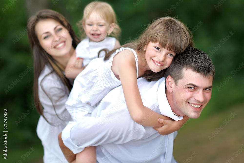 portrait of a happy family in summer nature