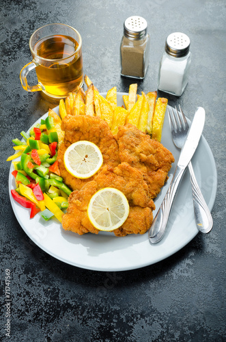 Schnitzel with french fries photo