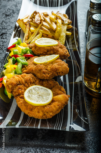 Schnitzel with french fries photo