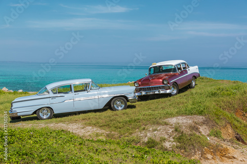 amazing view of old vintage classic cars on ocean background