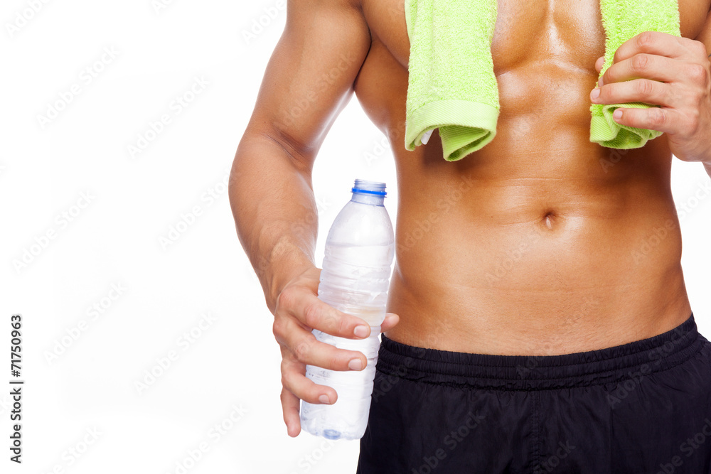 Naklejka premium Fitness man holding a bottle of water, isolated on white backgro