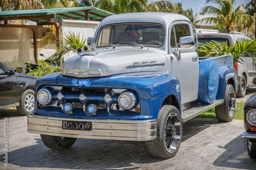 Blue, grey classic vintage pickup truck standing in garden