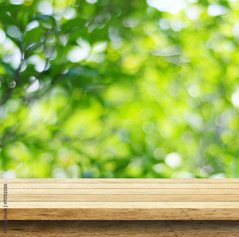 Empty wood table with blur green leaves bokeh background Empty wood table with blur green leaves bokeh background