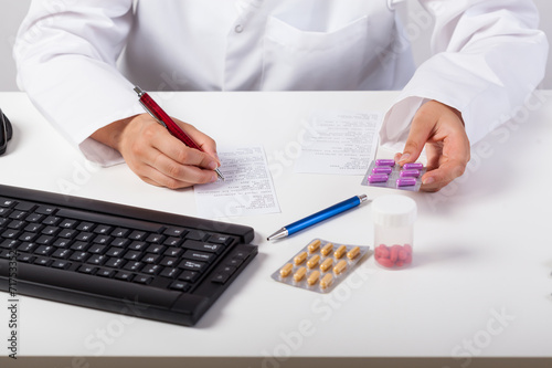 Pharmacist checking prescription