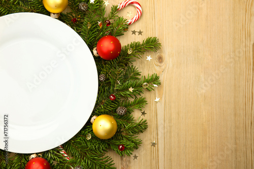 Christmas white plate with firtree on wooden background