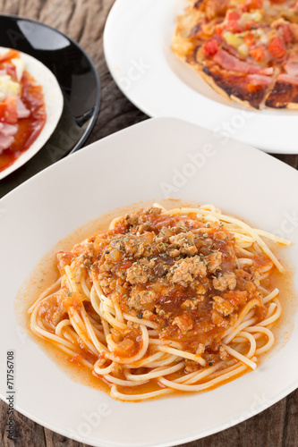 A portion of Italian spaghetti topped with minced pork in bologn