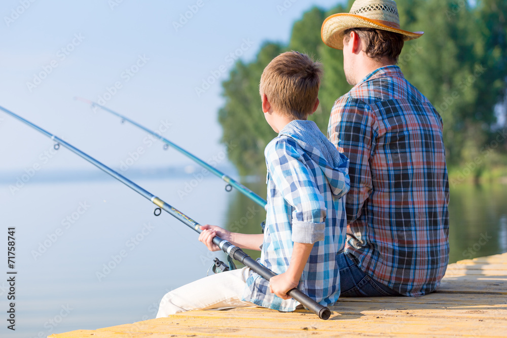 boy and his father fishing togethe boy and his father fishing togethe
