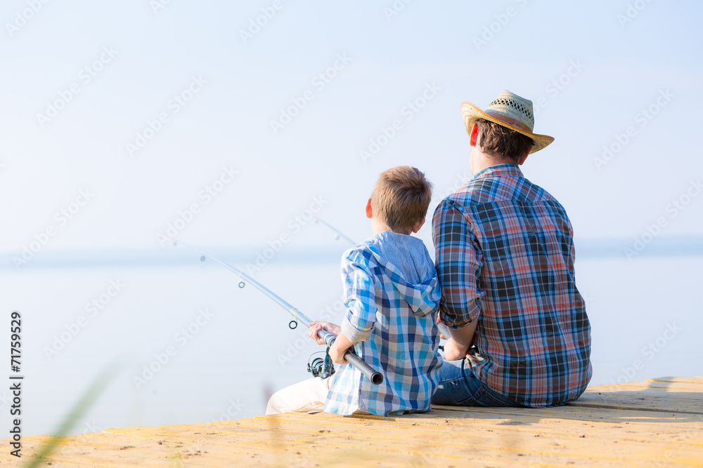 boy and his father fishing togethe boy and his father fishing togethe