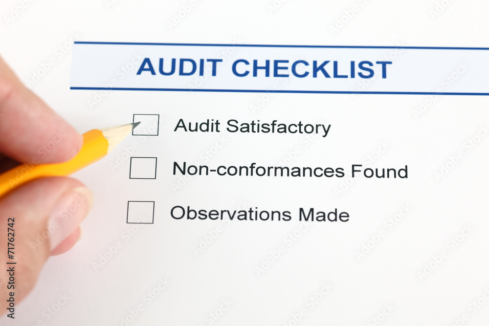 Audit checklist and human hand with pencil. Audit checklist and human hand with pencil.