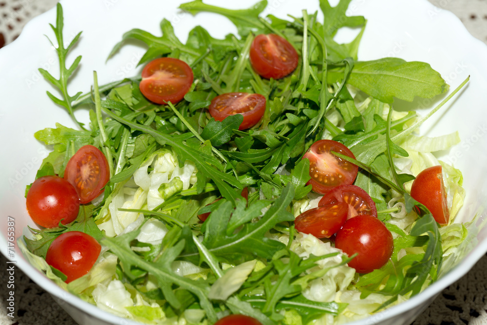 Heap of ruccola, lettuce leaves and cherry tomatoes Heap of ruccola, lettuce leaves and cherry tomatoes