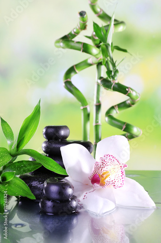 Spa stones, bamboo branches and white orchid © Africa Studio