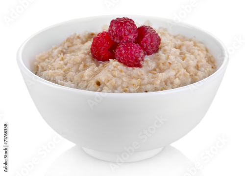 Tasty oatmeal with berries, isolated on white