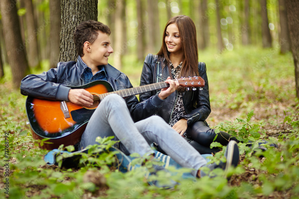 Teenagers playing guitar