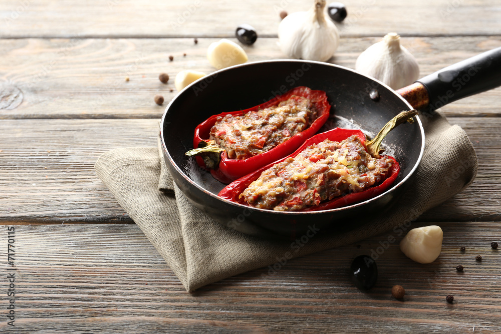 Delicious stuffed peppers in frying pan on table close-up Delicious stuffed peppers in frying pan on table close-up