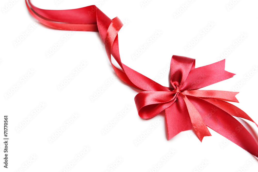 Shiny red ribbon with bow isolated on white Shiny red ribbon with bow isolated on white