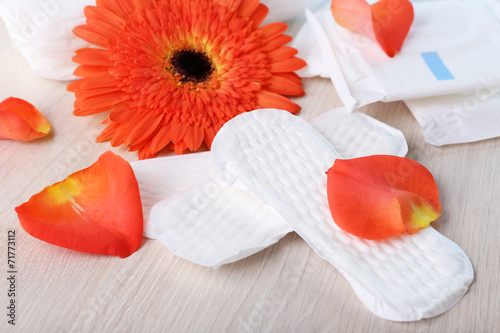 Fototapeta Naklejka Na Ścianę i Meble -  Sanitary pads, orange flower and rose petals
