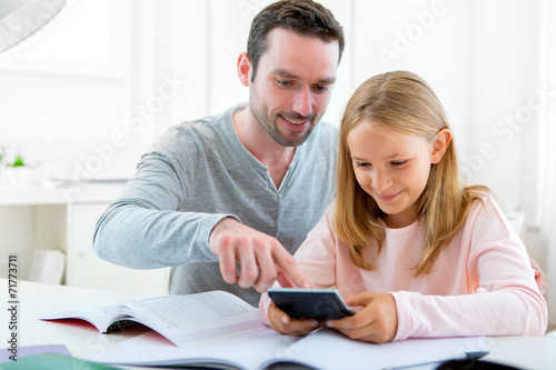 Father helping out her daughter for homework