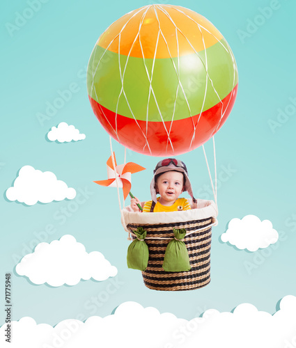 cheerful kid on hot air bal...