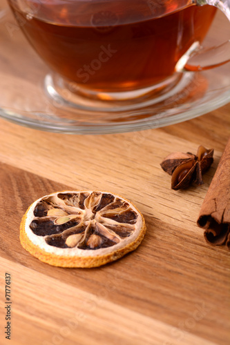 hot tea with lemon and cinnamon on wooden backgroubd