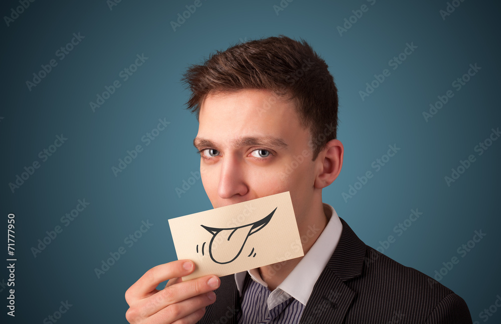 Happy businessman holding funny white card on his mouth Happy businessman holding funny white card on his mouth