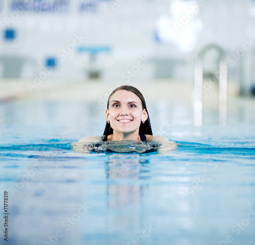 Portrait of a young woman in sport swimming pool © mr.markin
