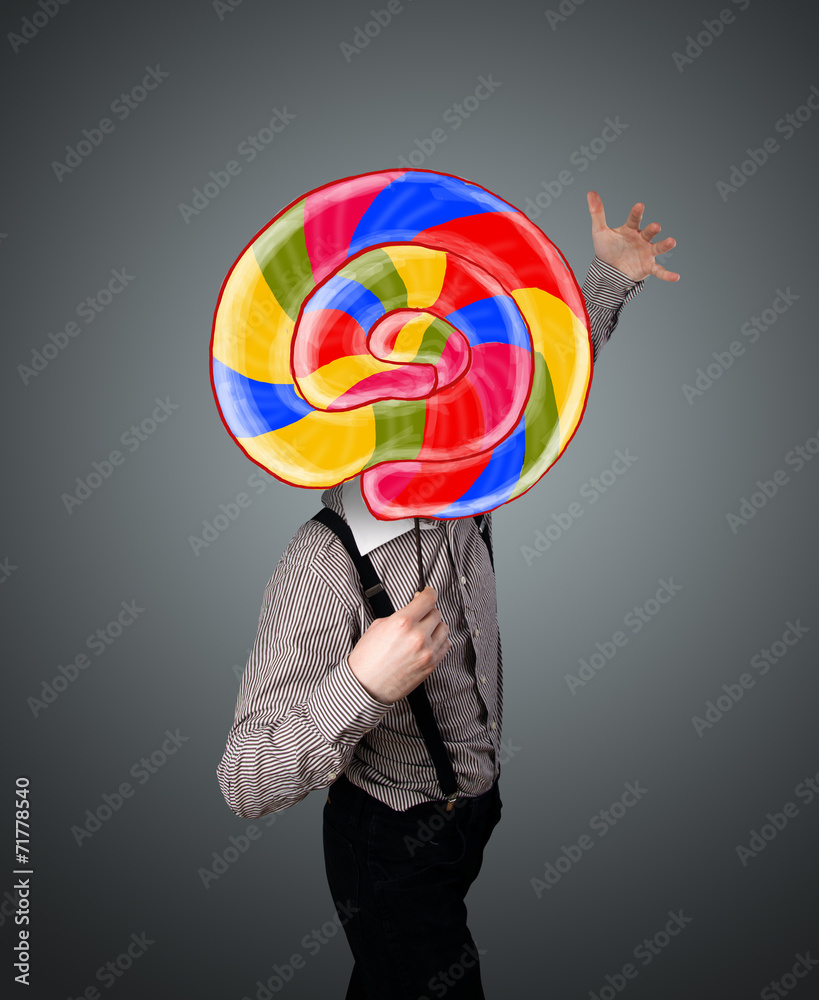Fototapeta premium Businessman holding a lollipop