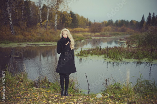 Beautiful elegant woman in a black coat © soup studio