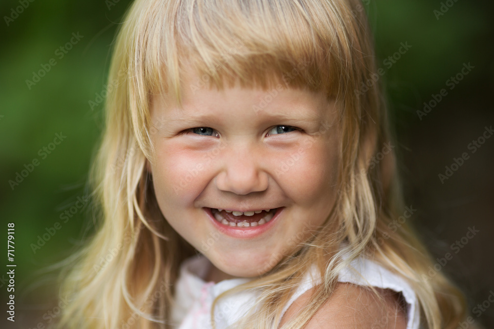 Happy little blonde girl cheerfully smiles Happy little blonde girl cheerfully smiles
