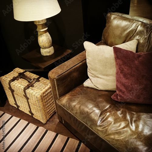 Fototapeta Naklejka Na Ścianę i Meble -  Leather sofa, lamp and rattan suitcase