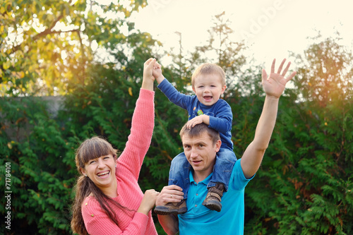 happy parents and son enjoyed a walk in the park