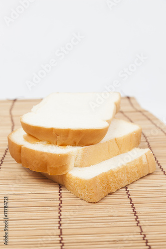 Sliced ​​bread on the wooden plate.