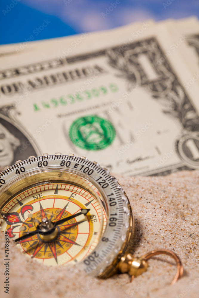Sea shells compass and dollar money on sand Sea shells compass and dollar money on sand
