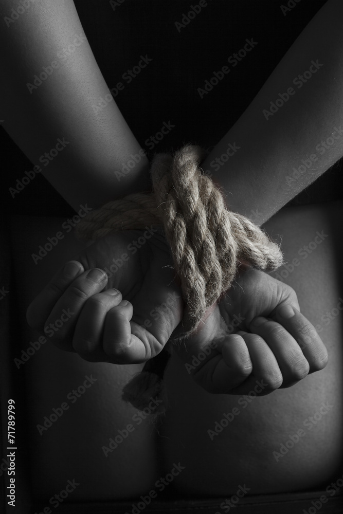 Fototapeta premium Nude submissive handcuffed woman, bondage act