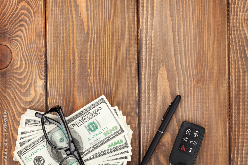 Money, glasses and car key on wooden table Money, glasses and car key on wooden table