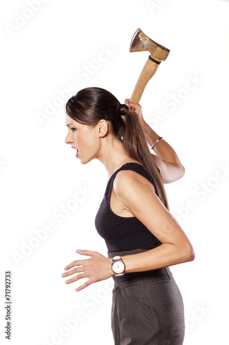 furious young woman swinging an ax