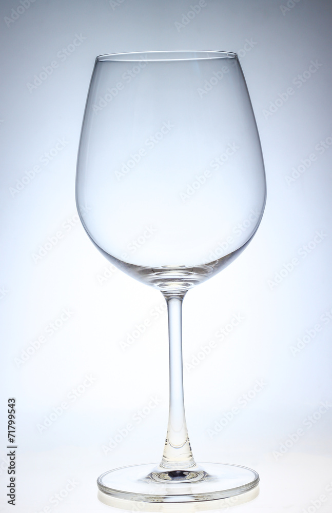 A full wine glass of water on a neutral background A full wine glass of water on a neutral background