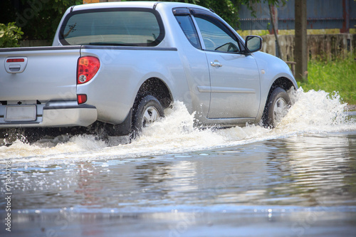 Splash by a car as it goes through flood water