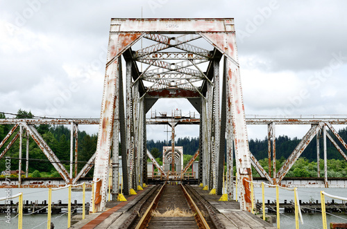 Large steel pivot railroad bridge spanning the Umpqua River bay  photo