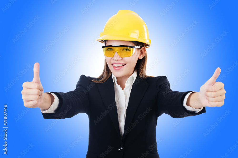 Young businesswoman with hard hat on white Young businesswoman with hard hat on white