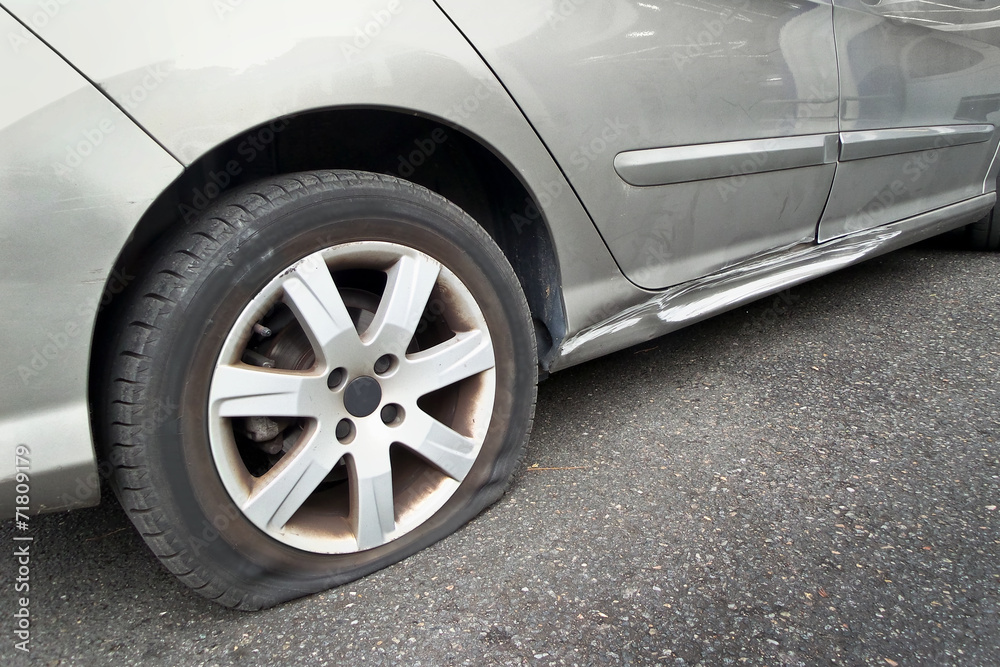 Close up of a flat rear tire on a car Close up of a flat rear tire on a car