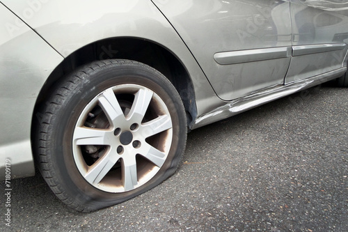 Flat rear tire on a car © Delphotostock