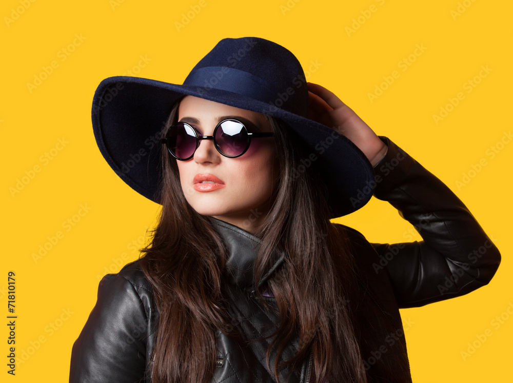 Style brunette girl on yellow background.