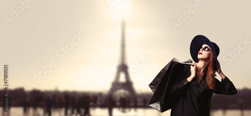 Photography Redhead women with shopping bags on parisian background.