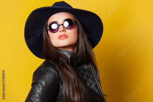 Style brunette girl on yellow background.