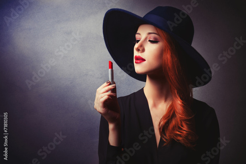 Style redhead women in black wth lipstick on classic background